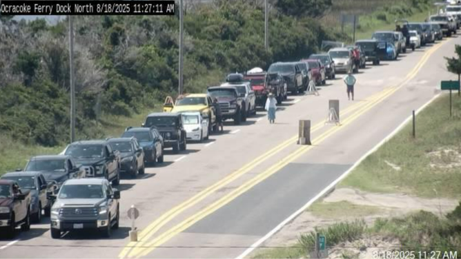 This image provided by the North Carolina Department of Transportation shows a line of vehicles waiting to evacuate Ocracoke Island ahead of life-threatening impacts from Hurricane Erin.